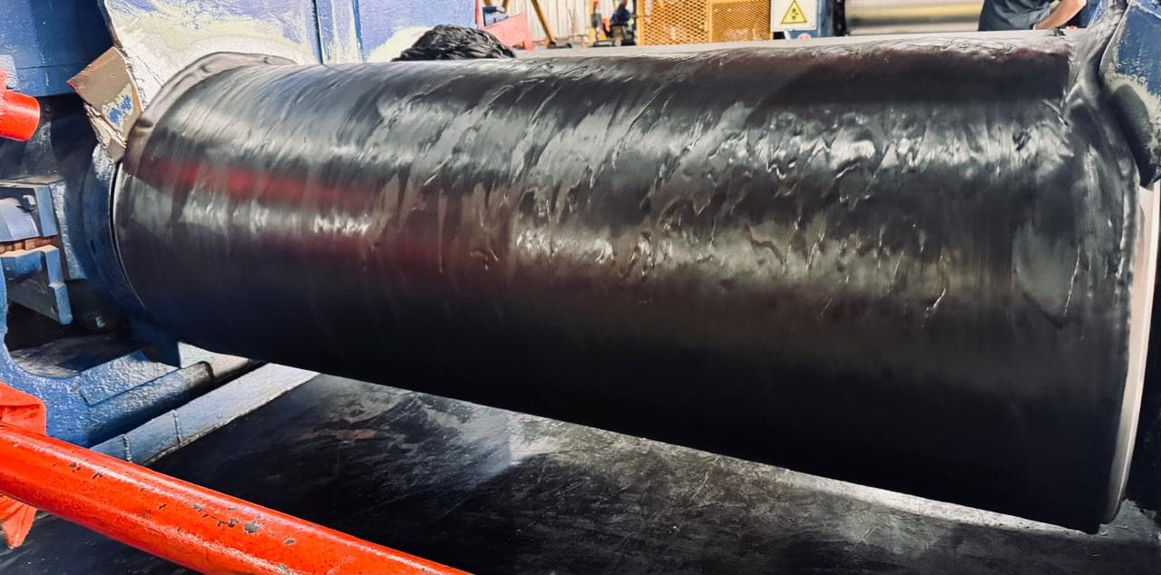 Black rubber sheeting on calender during manufacturing