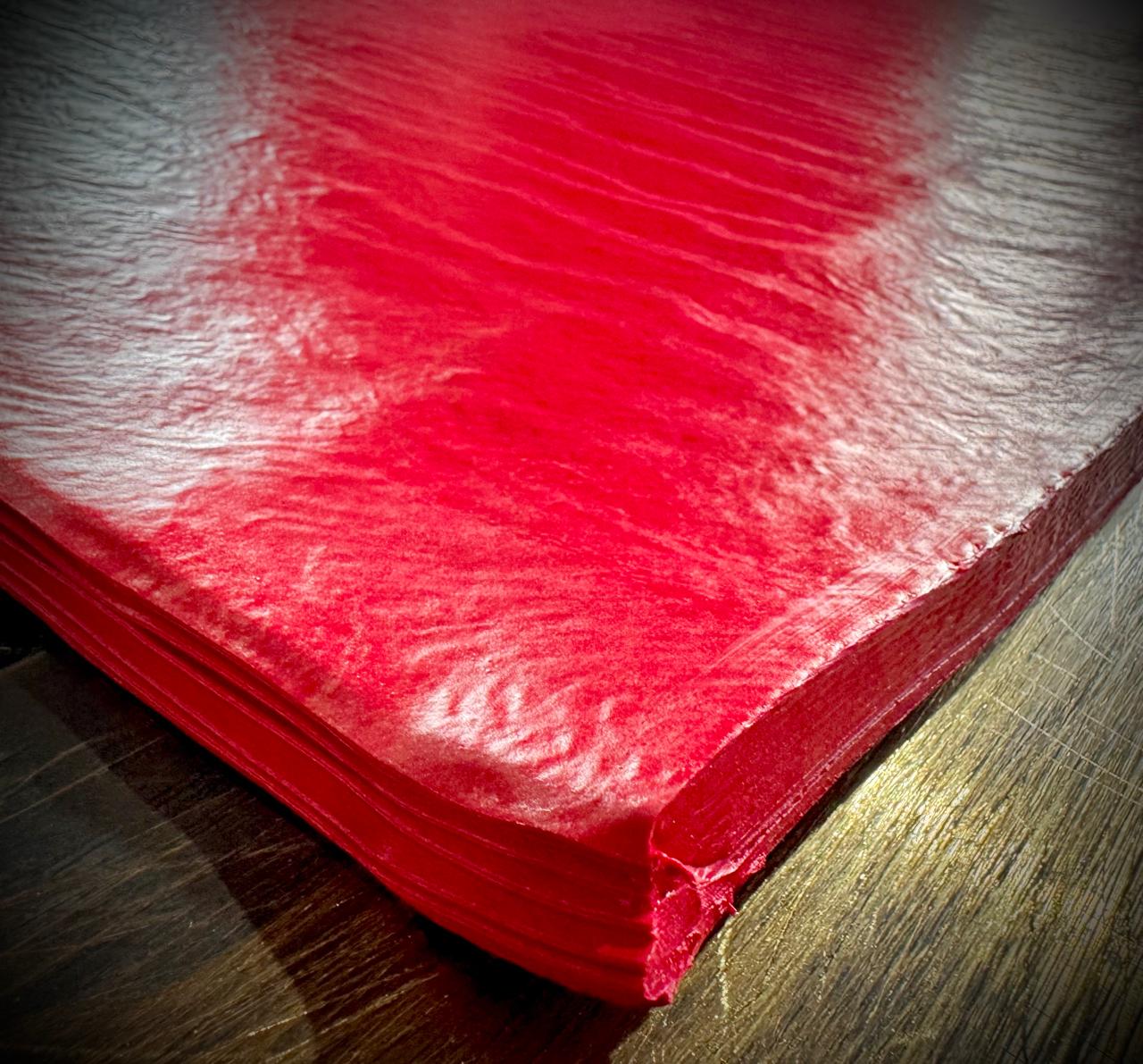 Pink rubber compound being processed through rolling mill